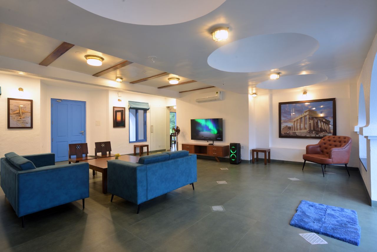 3BHK Villa drawing room: Ample space with a large TV for viewing.