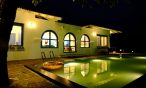 3BHK Villa pool at night: A calm and inviting scene.