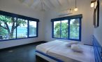 Relaxing bedroom in 3BHK villa: Enjoy the serene view from the window.