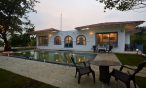 Daylight view of swimming pool in 3BHK villa: Inviting oasis for relaxation.
