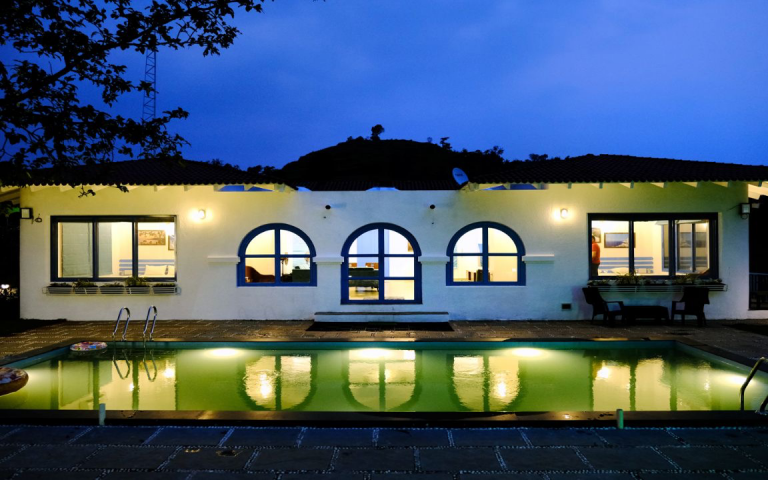 3BHK Villa pool at night: A calm and inviting scene.