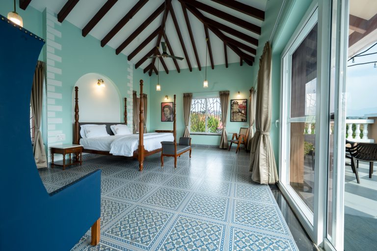Bedroom 1 of a 4bhk Alang cottage villa, featuring a scenic view of serene surroundings or lush landscapes, with comfortable furnishings and natural light creating a peaceful retreat