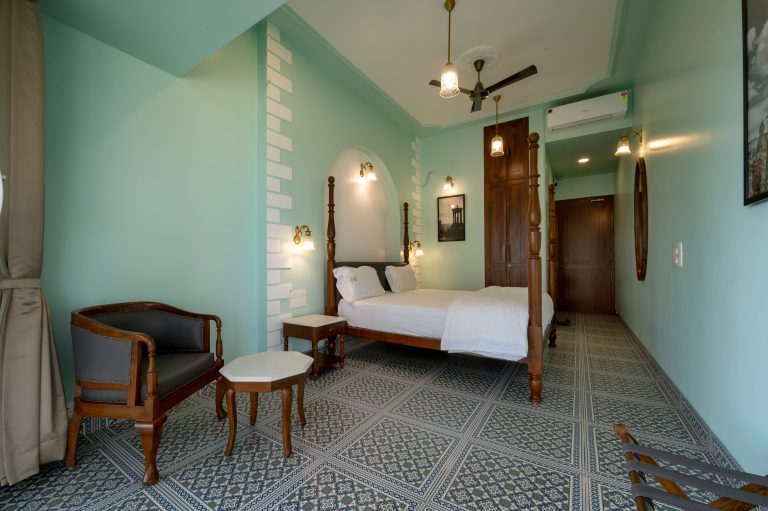 Bedroom 2 of a 4bhk Alang cottage villa, showcasing cozy furnishings, soft lighting, and a welcoming ambiance for relaxation and comfort.