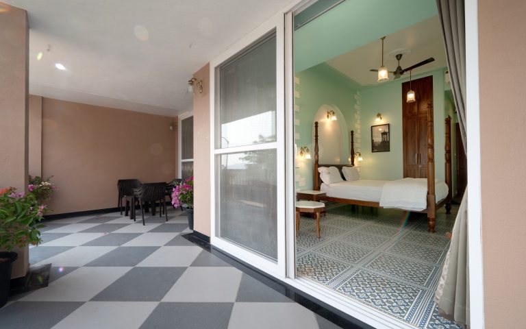 The balcony of Bedroom 2 in a 4bhk Alang cottage villa, offering a serene outdoor space with panoramic views, perfect for relaxation and enjoying the surrounding natural beauty.