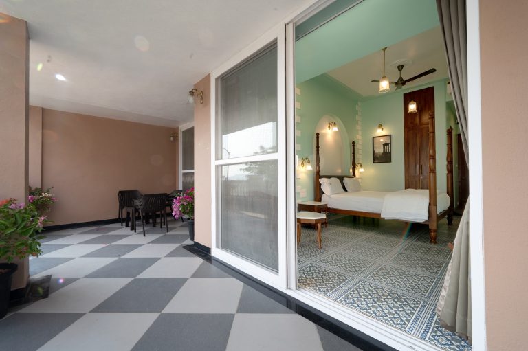 The balcony of Bedroom 2 in a 4bhk Alang cottage villa, offering a serene outdoor space with panoramic views, perfect for relaxation and enjoying the surrounding natural beauty.