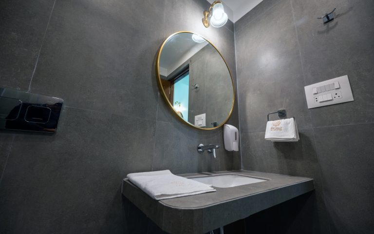 The washroom of Bedroom 2 in a 4bhk Alang cottage villa, featuring modern fixtures, clean lines, and ample natural light, creating a refreshing and comfortable space for personal care routines.