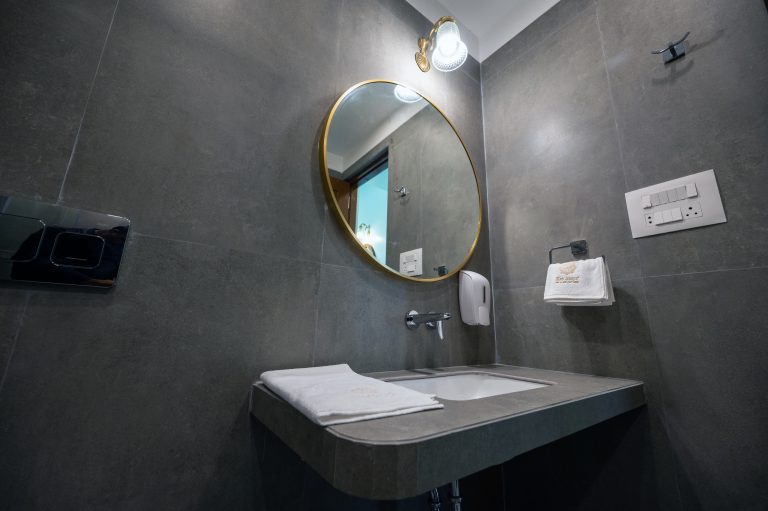 The washroom of Bedroom 2 in a 4bhk Alang cottage villa, featuring modern fixtures, clean lines, and ample natural light, creating a refreshing and comfortable space for personal care routines.